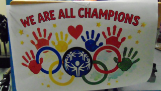  A colorful poster that reads WE ARE ALL CHAMPIONS